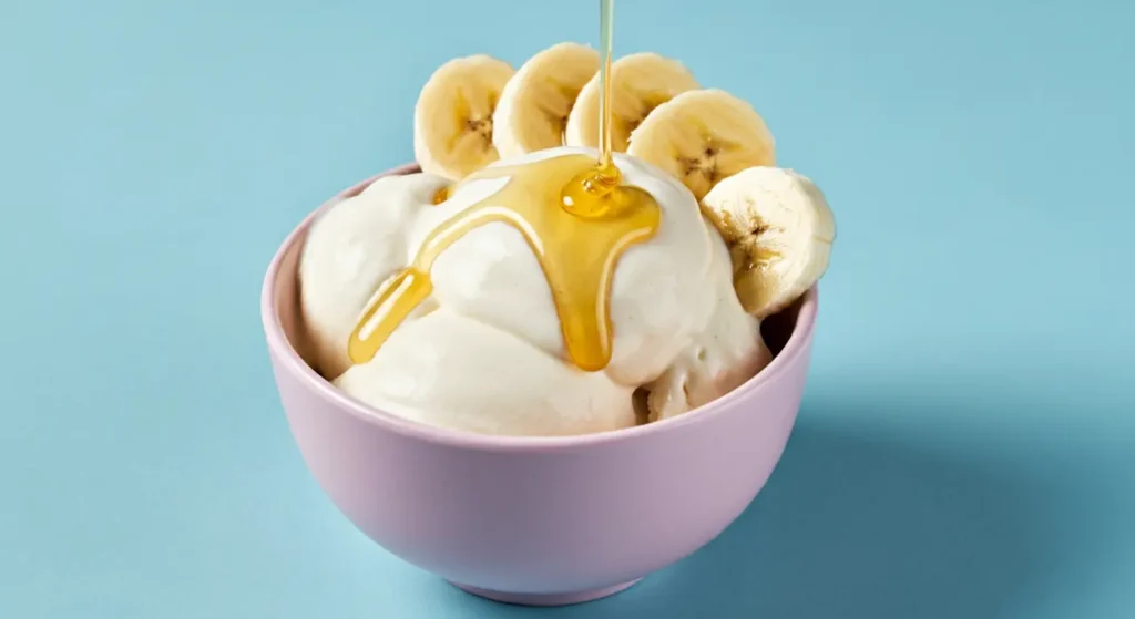 Banana cream cheese frozen yogurt with banana slices and honey drizzle